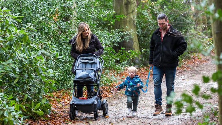 Family enjoying a walk in the grounds at Rufford Old Hall, Lancashire